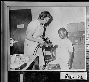 Photograph of Mrs. Jean Rootes vaccinating a young African-American boy, Cuthbert, Randolph County, Georgia, 1976 or 1977