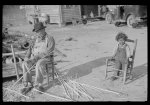 [Untitled photo, possibly related to: Mixed-breed Indian, white and Negro, near Pembroke Farms, making new chair seat. North Carolina]