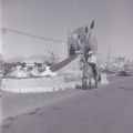 Film negatives of Joe Louis riding a horse next to the Moulin Rouge float in the Helldorado parade, May 5, 1955