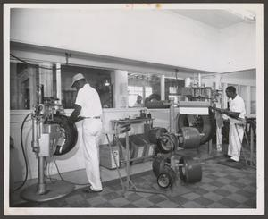 Two Men Working at Johnnie Johnson Tire Co.