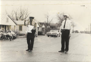 Two Montgomery policemen standing in the street during the Selma to Montgomery March.