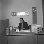 Bradley campaign staff member posing at a desk, Los Angeles, 1973