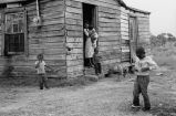 Family standing outside house.