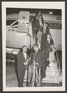 Men Disembarking From an Airplane