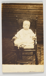 Photographic postcard of a baby in a stroller