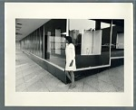 Woman leaning against corner of building