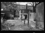 Children playing in backyard in slum area near capitol. This area inhabited by both white and Negro, Washington, D.C.