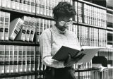 A Marquette Law School student consults a reference work in the library, circa 1985