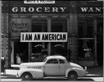 Oakland, Calif., Mar. 1942. A large sign reading "I am an American" placed in the window of a store, at [401 - 403 Eighth] and Franklin streets, on December 8, the day after Pearl Harbor. The store was closed following orders to persons of Japanese descent to evacuate from certain West Coast areas. The owner, a University of California graduate, will be housed with hundreds of evacuees in War Relocation Authority centers for the duration of the war