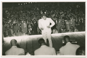 Print of Cab Calloway conducting his band with a large audience visible