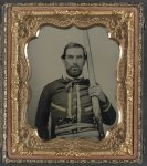 [Unidentified soldier in Confederate quantrillian battleshirt with double barrel percussion shotgun and cocked Colt Navy revolver]