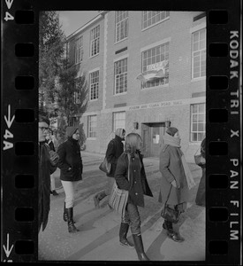 White students parade with placards outside Ford Hall at Brandeis University