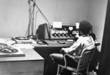 A student operates the equipment in a recording booth for WMUR, 1973-1974