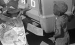 African American boy watching fish getting weighed on scale: Image 1