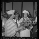 Coretta Scott King receiving flowers upon arrival at Los Angeles airport, 1965