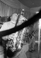 Bobby Moore playing the saxophone on stage at the Laicos Club in Montgomery, Alabama, during a performance by his group, Bobby Moore and the Rhythm Aces.