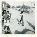 Photograph of Dell Ray Rhodes with her brother an an unidentified male child in Westside Alley, 1955