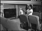 Worker dusting Venetian blinds in Zephyr coach, 14th Street passenger yards, Chicago, May 1948