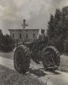 Photograph; Jim drives new tractor up to house at noon.