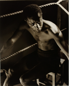 Unidentified boxer sitting in ring