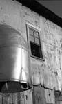 African American man looking out of window at cotton processing building