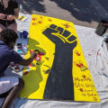 Raised fist mural in progress for the Clayton Jackson McGhie 100 Year Memorial