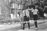 Two men walking on sidewalk at Duke University.