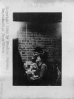 Mississippi State Sovereignty Commission photograph of a white female and black male sitting next to each other at a table in front of a brick wall in an unknown location in Greenwich Village, New York, New York, 1962 March 18