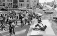 Chewy Lee and Jimmy "Bodyrock" Robinson of the Freak-a-Zoids make dance moves on the ground of Peace Train's mobile stage, Central Row and Main Street