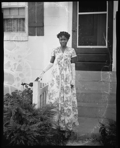 Surrat, July 20 [woman in front of a house : cellulose acetate photonegative]