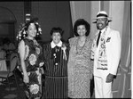 Three African American women and a man posing together in a ballroom, Los Angeles, 1986