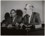 Two Men seated at Desk