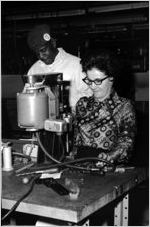 Woman assembles a motor shaft for an appliance, 1975-12-18