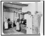 [Students preparing dinner in large kitchen at the Tuskegee Normal and Industrial Institute]