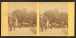 Thumbnail for View of African American groom holding reins of horse with rider