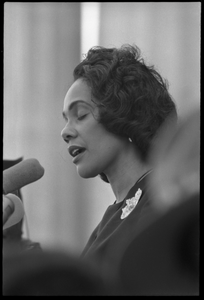 Coretta Scott King addressing the Solidarity Day crowd at the Poor People's March on Washington, speaking against the War in Vietnam Portrait in profile, at the microphones