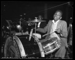 Thumbnail for African American boy playing drum set at 1941 Children's Christmas party at May Co. department store in Los Angeles, Calif