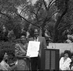 Thumbnail for Maxine Waters holding a commendation next to Tom Bradley, Los Angeles, 1986