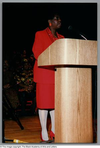 Photograph of a woman in a red suit