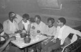 Robert Flowers, Barbara Howard Flowers, and others, seated with another man at a table at the Laicos Club in Montgomery, Alabama.