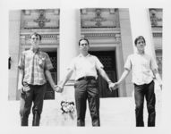 Mississippi State Sovereignty Commission photograph of Richard Barrett holding the hands of two teenagers on the steps of the Mississippi State Capitol during a demonstration, Jackson, Mississippi, 1967 July 30