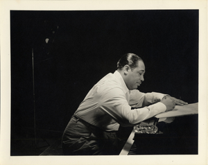 Duke Ellington composing at the piano : black-and-white photoprint.