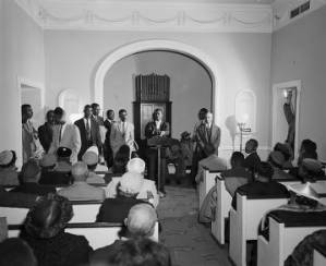 Fred Shuttlesworth speaking at a church meeting during a campaign to integrate buses in Birmingham, Alabama.