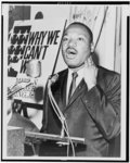 [Martin Luther King, Jr., three-quarter-length portrait, standing, facing front, at a press conference]