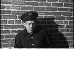 Oakland firefighter leaning against brick wall