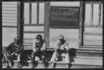 Negroes sitting on foot of the T&amp;P (Texas and Pacific) railroad station, New Roads, Louisiana. Note frequency of train operations