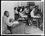 [White students in class at the University of Oklahoma, and G.W. McLaurin, an African American, seated in anteroom]