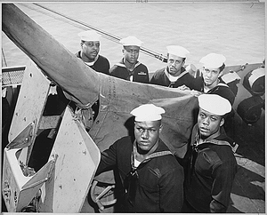 "A gun crew of six Negroes who were given the Navy Cross for standing by their gun when their ship was damaged by enemy attack in the Philippine area."