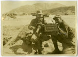 Squad members Brock and Borders demonstrate operation of Korean War machine gun