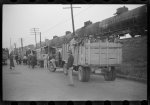 [Untitled photo, possibly related to: Day laborers being hired for cotton picking on Mississippi and Arkansas plantations. Between four and six-thirty every morning during the season, near the Hallan Bridge in Memphis, Tennessee, crowds of Negroes in the streets gather and are loaded into trucks by drivers who bid, and offer them anywhere from fifty cents to one dollar per day]